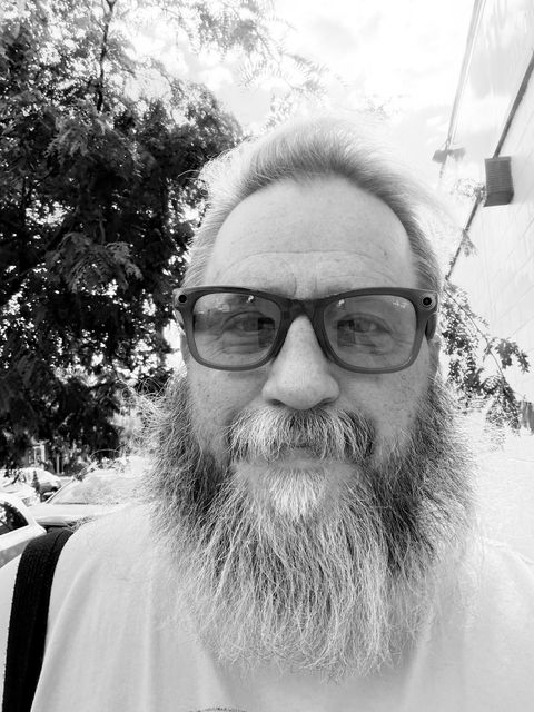 Jason, founder of New To Fishtown, a bearded man in glasses on a Fishtown sidewalk